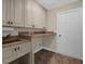 Well-organized laundry room featuring built-in sink, granite countertops and ample cabinet space at 8620 Willow Kane Ct, Orlando, FL 32835