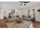 Comfortable living room with neutral tones, a ceiling fan, and a staircase leading upstairs at 8620 Willow Kane Ct, Orlando, FL 32835