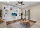 Bright living room featuring built-in shelves, a ceiling fan, and a rustic coffee table at 8620 Willow Kane Ct, Orlando, FL 32835