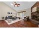 Cozy living room with a brick fireplace, hardwood floors, and French doors leading outdoors at 8620 Willow Kane Ct, Orlando, FL 32835