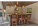 Outdoor kitchen with granite countertops, bar stool seating, stainless steel grill, and wood plank ceiling at 8620 Willow Kane Ct, Orlando, FL 32835