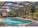 Inviting in-ground pool with screened enclosure offering privacy and relaxation at 8620 Willow Kane Ct, Orlando, FL 32835