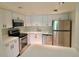 Modern kitchen with stainless steel appliances and white cabinets at 90 Moree Loop # 16, Winter Springs, FL 32708