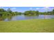 Peaceful lake view with grassy shoreline and trees at 90 Moree Loop # 16, Winter Springs, FL 32708