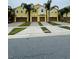 Three-unit townhome building with attached garages and palm trees at 9884 Red Eagle Dr, Orlando, FL 32825