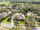 Aerial view showcasing community with mature trees and manicured lawns at 103 Arrowhead Ct, Winter Springs, FL 32708