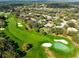 Aerial view showcases lush golf course, manicured lawns and sand traps, surrounded by tree-lined residential neighborhood at 103 Arrowhead Ct, Winter Springs, FL 32708