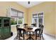 A formal dining area features large windows, an antique cabinet, and decor at 103 Arrowhead Ct, Winter Springs, FL 32708