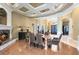 Elegant dining area with a fireplace, wood floors, coffered ceilings, and decorative lighting at 103 Arrowhead Ct, Winter Springs, FL 32708