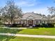 Charming front exterior with manicured lawn, mature trees, and inviting entrance at 103 Arrowhead Ct, Winter Springs, FL 32708