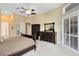 Bright main bedroom featuring neutral carpet, tray ceiling, and a private entrance to the outdoor lanai at 103 Arrowhead Ct, Winter Springs, FL 32708