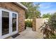 Brick patio features a walkway with lush, mature landscaping at 103 Arrowhead Ct, Winter Springs, FL 32708