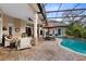 Relaxing screened-in pool with lounge chairs, covered lanai, and lush landscaping for ultimate privacy at 103 Arrowhead Ct, Winter Springs, FL 32708