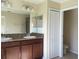 Double vanity bathroom with granite countertop and linen closet at 10975 Savannah Landing Cir, Orlando, FL 32832