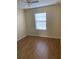 Simple bedroom with wood-look laminate floors and ceiling fan at 10975 Savannah Landing Cir, Orlando, FL 32832