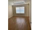 Spacious bedroom with large window and light wood laminate flooring at 10975 Savannah Landing Cir, Orlando, FL 32832