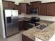 Modern kitchen with stainless steel appliances and granite countertops at 10975 Savannah Landing Cir, Orlando, FL 32832