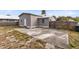 Backyard view of home with large concrete patio at 1114 Wyoming Ave, St Cloud, FL 34769