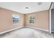 Well-lit bedroom with neutral walls and carpet flooring at 1114 Wyoming Ave, St Cloud, FL 34769