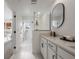 Spa-like bathroom with a vanity, walk-in shower, and a large mirror at 11574 Buoy Point Pl, Orlando, FL 32832