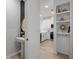 Bright hallway with built-in shelving and a powder room at 11574 Buoy Point Pl, Orlando, FL 32832