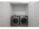 Laundry room with washer and dryer in a closet at 11574 Buoy Point Pl, Orlando, FL 32832