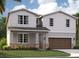 Two-story home with shingle siding, stone accents, and a two-car garage at 1200 White Ash Loop, Deland, FL 32720