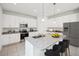 Modern kitchen featuring white cabinets, granite countertops, and stainless steel appliances at 1200 White Ash Loop, Deland, FL 32720