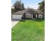 Single-story house, gray exterior, two-car garage, spacious lawn at 1210 Kenway Ave, Deltona, FL 32738