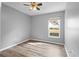 Bright bedroom featuring a window, ceiling fan, and wood-look flooring at 1210 Kenway Ave, Deltona, FL 32738