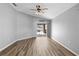 Bright Gathering room featuring wood-look floors and sliding glass doors leading to the backyard at 1210 Kenway Ave, Deltona, FL 32738