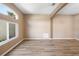 Living room with wood-look floors and large window at 1210 Kenway Ave, Deltona, FL 32738