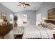 Main bedroom with wood-look floors, ensuite bathroom, and plenty of natural light at 1210 Kenway Ave, Deltona, FL 32738