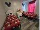 Charming bedroom with two twin beds, Mickey Mouse bedding, and decorative touches at 1230 Las Fuentes Dr, Kissimmee, FL 34746