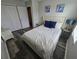 Comfortable bedroom features a queen bed, stylish lamps, and wood-look flooring at 1230 Las Fuentes Dr, Kissimmee, FL 34746