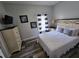 Comfortable bedroom with a queen-size bed, dresser, and stylish decor at 1230 Las Fuentes Dr, Kissimmee, FL 34746