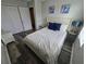 Comfortable bedroom features a queen bed, stylish lamps, and wood-look flooring at 1230 Las Fuentes Dr, Kissimmee, FL 34746