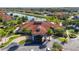 Overhead shot of a community clubhouse with Spanish tile roof, surrounded by palm trees and lush landscaping at 1230 Las Fuentes Dr, Kissimmee, FL 34746