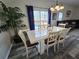 Bright dining area with a modern table, stylish chairs, and sliding glass doors to a pool at 1230 Las Fuentes Dr, Kissimmee, FL 34746