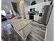 Modern kitchen with granite counters, white cabinets, and stainless steel appliances at 1230 Las Fuentes Dr, Kissimmee, FL 34746