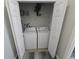 A laundry room features a white washer and dryer set, with shelf and storage at 1230 Las Fuentes Dr, Kissimmee, FL 34746