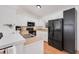 Kitchen with white cabinets, black appliances, and tile floor at 1267 Varnado Rd, Groveland, FL 34736