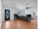 Living room features tile floors and grey sectional sofa at 1267 Varnado Rd, Groveland, FL 34736