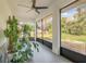 Relaxing screened porch with ceiling fan, potted plants, and backyard view at 1267 Varnado Rd, Groveland, FL 34736