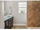 Bathroom with double vanity and herringbone tile at 128 Tildenville School Rd, Winter Garden, FL 34787