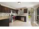 Modern kitchen with dark cabinets and granite countertops at 128 Tildenville School Rd, Winter Garden, FL 34787