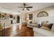 Living room with hardwood floors and two beige sofas at 128 Tildenville School Rd, Winter Garden, FL 34787