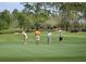 Four golfers putting on a lush green golf course at 13586 Abberwick Dr, Orlando, FL 32832