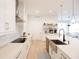 Sleek kitchen with white cabinets, herringbone tile, and stainless steel appliances at 13586 Abberwick Dr, Orlando, FL 32832