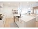 Modern kitchen with white cabinets, a large island, and a herringbone backsplash at 13586 Abberwick Dr, Orlando, FL 32832